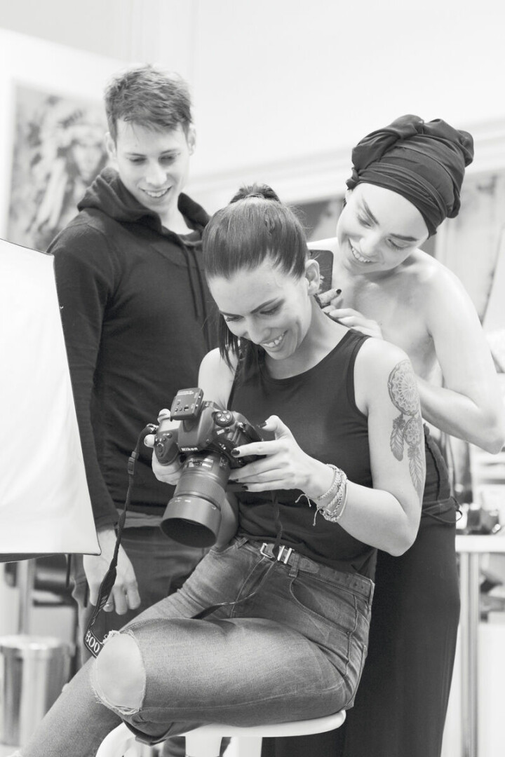 Linnea Frank arbetar med en serie bilder för att marknadsföra mobilskal med sin konst. Bakom Linneas rygg står assistenten Felix och tittar på resultatet tillsammans med modellen Sarah Grundén.