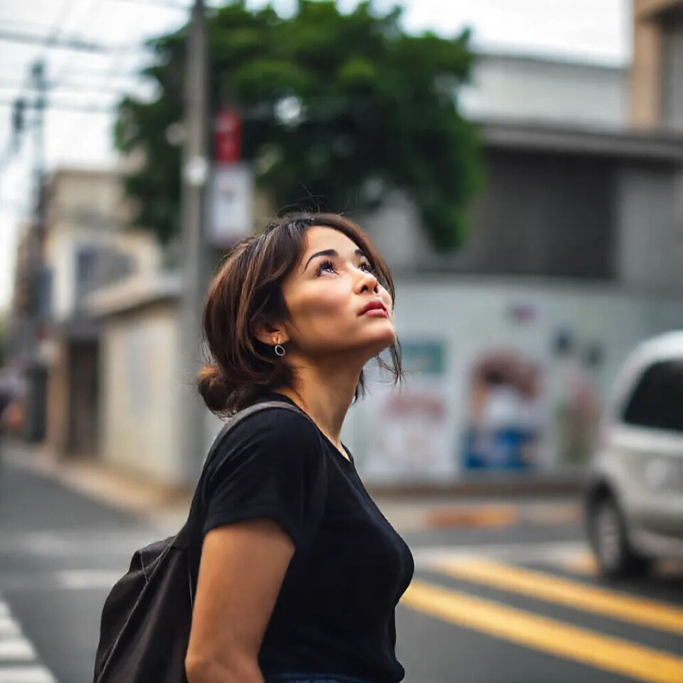 Prompt: 'A woman standing in the street'.